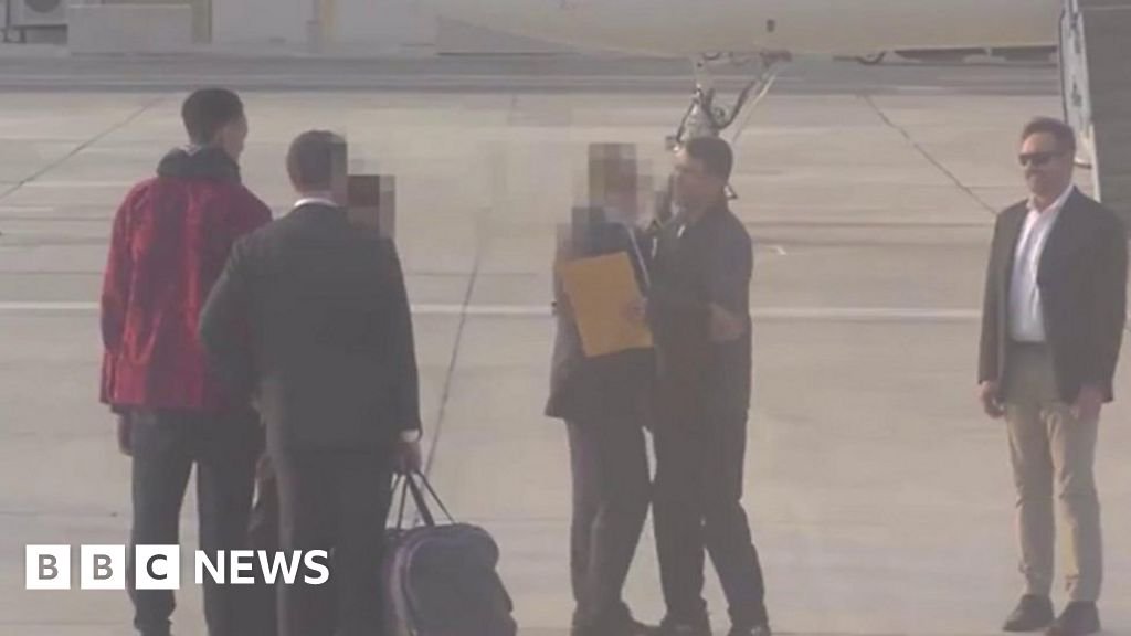 The moment Griner and Bout cross on airport tarmac