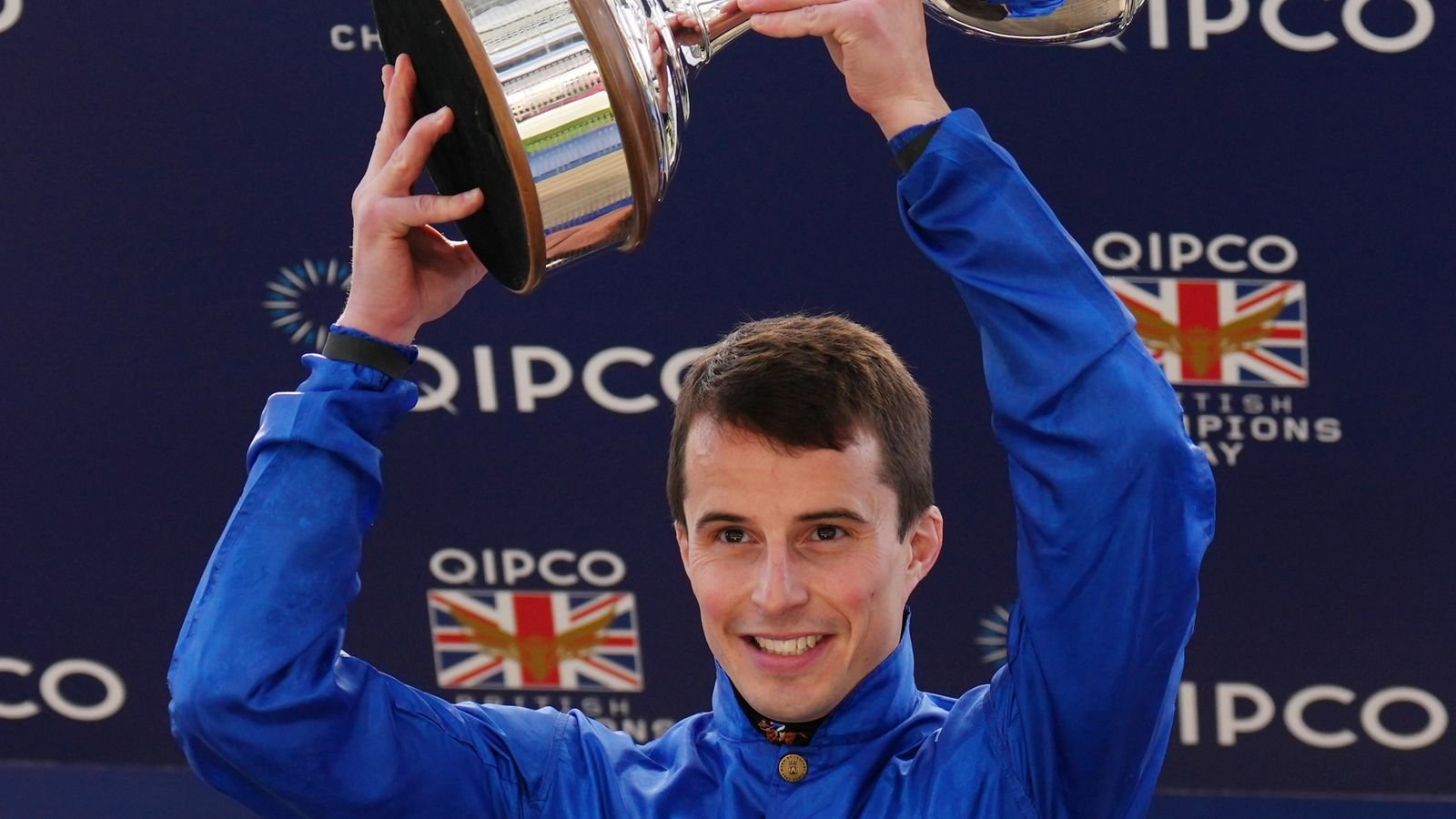 William Buick holds aloft the champion jockeys' trophy at Ascot