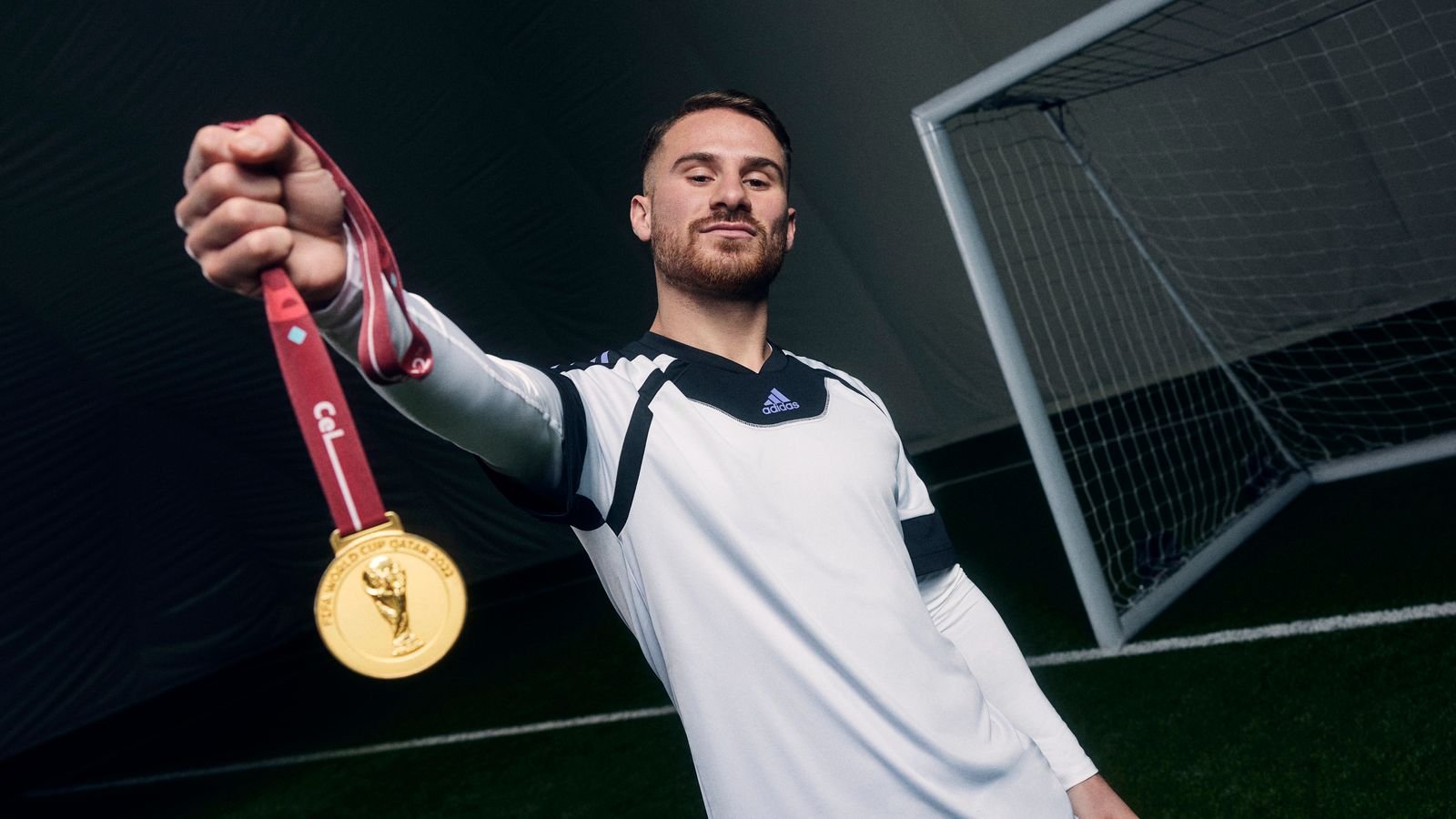 Brighton's Alexis Mac Allister with his World Cup medal for Argentina at an adidas shoot