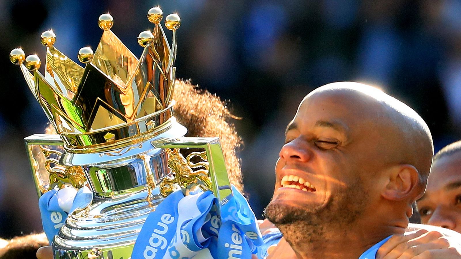 Manchester City's Vincent Kompany celebrates with the trophy during the Premier League match at the AMEX Stadium, Brighton.