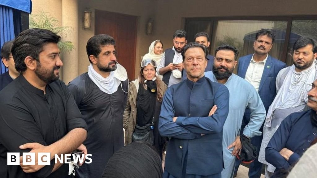 Imran Khan greets supporters after police withdraw from around ex-PM's home