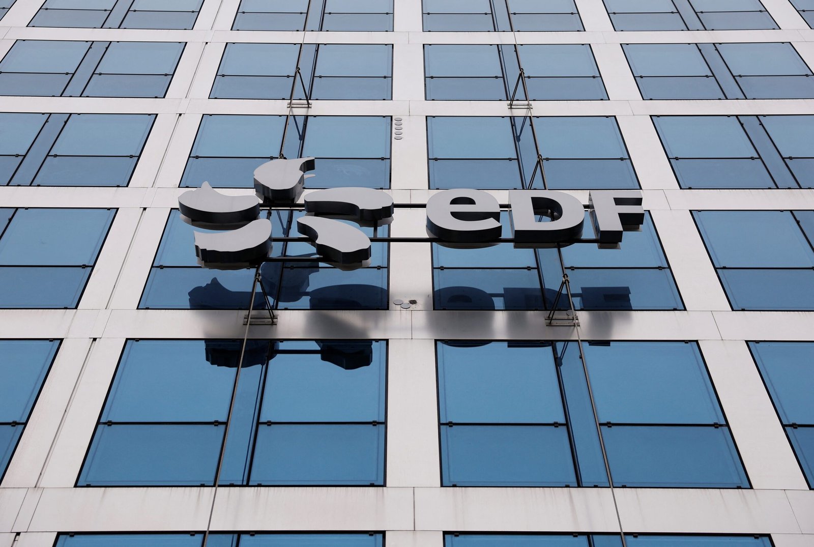 FILE PHOTO: A logo is seen on the facade of French state-owned utility EDF building during the presentation of the 2022 annual results in Paris, France February 17, 2023. REUTERS/Christian Hartmann/File Photo